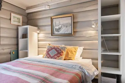 a bedroom with a bed and wooden walls at Trysilfjell nord 590 by Vacation Trysil in Trysil