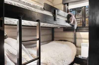 a bunk bed with a cat sitting on top of it at Trysilfjell nord 590 by Vacation Trysil in Trysil