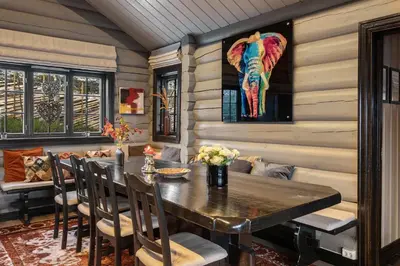 a dining room with a table and a painting of an elephant at Trysilfjell nord 590 by Vacation Trysil in Trysil