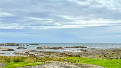 a beach with rocks and the ocean on a cloudy day at Apartment centrally located in Bud in Bud