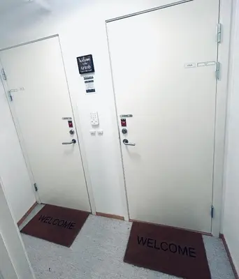 two elevator doors with welcome signs in a room at Riverside studioapartment 100m from trainstation! in Trondheim