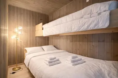 a bedroom with a bed with two bunk beds at Modern ski-in-ski-out apartment in Hemsedal in Hemsedal