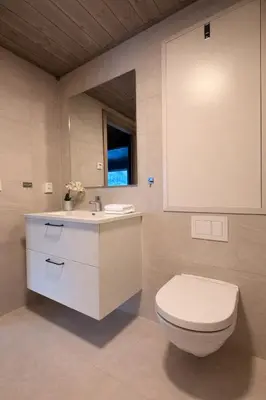 a bathroom with a white toilet and a sink at Modern ski-in-ski-out apartment in Hemsedal in Hemsedal