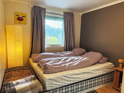 a small bedroom with a bed and a window at Holiday Home Høyanger Panorama by Interhome in Høyanger