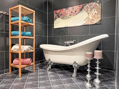 a bathroom with a tub and a shelf with towels at Holiday Home Høyanger Panorama by Interhome in Høyanger