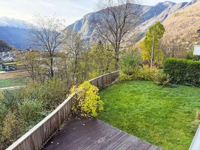 a wooden walkway in a garden with mountains in the background at Holiday Home Høyanger Panorama by Interhome in Høyanger