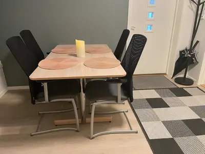 a dining room table with black chairs around it at Flott leilighet med nydelig utsikt i et stille og rolig boligområde in Bergen