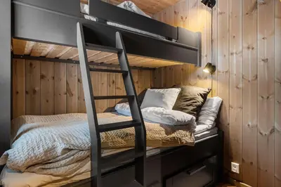 a bunk bed with a ladder in a room at Trysiltunet 28A by Vacation Trysil in Trysil