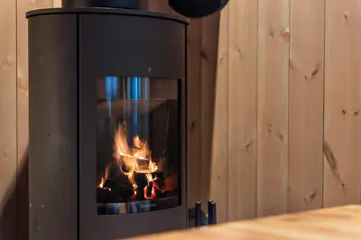 a fireplace with a fire inside of it at Trysiltunet 28A by Vacation Trysil in Trysil
