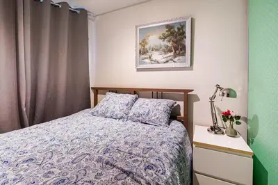a bedroom with a bed and a picture on the wall at Apartment in the heart of Bergen in Bergen