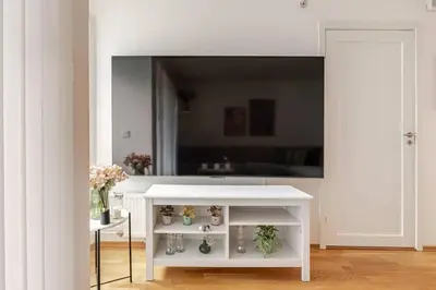 a white table in a room with a mirror at Apartment in the heart of Bergen in Bergen