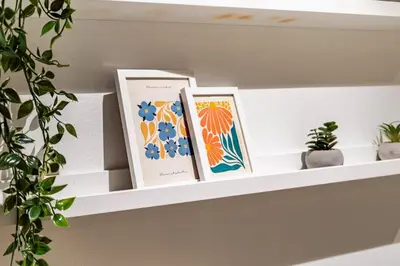 three books sitting on a shelf with plants at Apartment in the heart of Bergen in Bergen