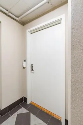 a large white door in a room with a tile floor at Apartment in the heart of Bergen in Bergen