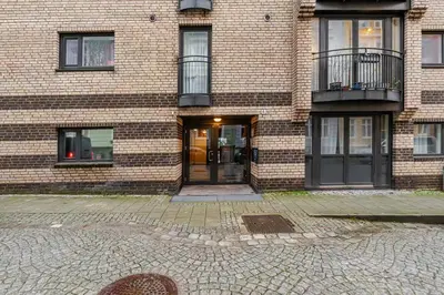 a brick building with a door and a balcony at Apartment in the heart of Bergen in Bergen