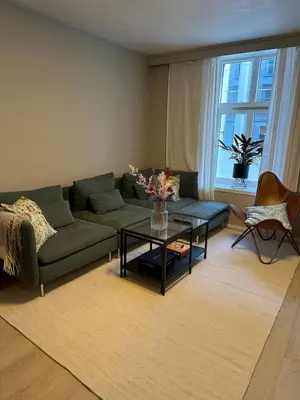 a living room with a couch and a table at Cozy apartment in the middle of Bergen city center in Bergen