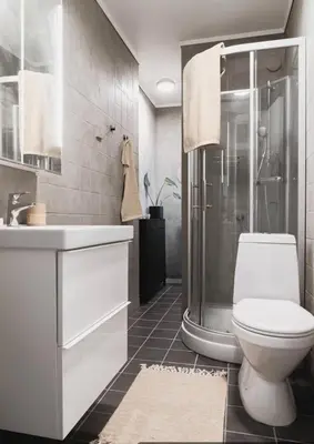 a bathroom with a white toilet and a shower at Cozy apartment in the middle of Bergen city center in Bergen