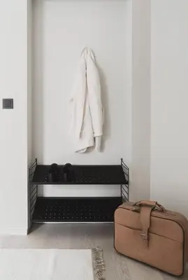 a suitcase sitting on the floor next to a white wall at Cozy apartment in the middle of Bergen city center in Bergen