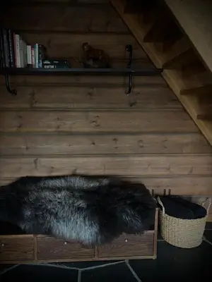 a fur rug on a wooden shelf in a attic at Great mountain cabin with 12 beds in Vågsli