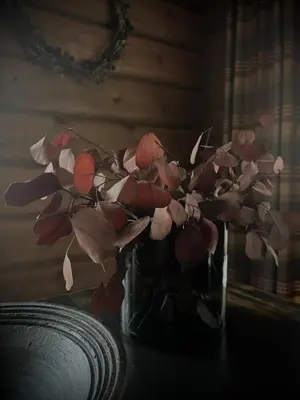 a vase of flowers sitting on a table at Great mountain cabin with 12 beds in Vågsli