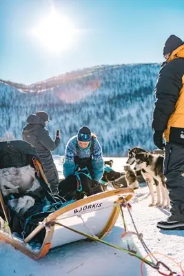 a group of people on a boat in the snow with a dog at Great mountain cabin with 12 beds in Vågsli