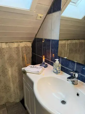 a bathroom with a sink and a mirror at Cabin by the lake in Sveio