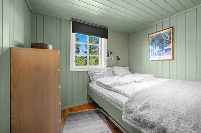 a bedroom with a bed and a window at Cabin in Hovden with Beautiful views in Bykle