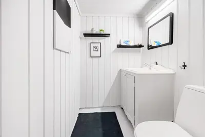 a white bathroom with a toilet and a sink at Cabin in Hovden with Beautiful views in Bykle