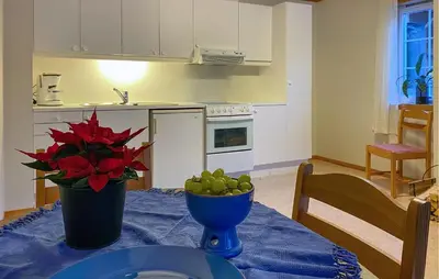 a kitchen with a table with a bowl of fruit on it at Amazing Apartment In Verma With Wifi in Verma