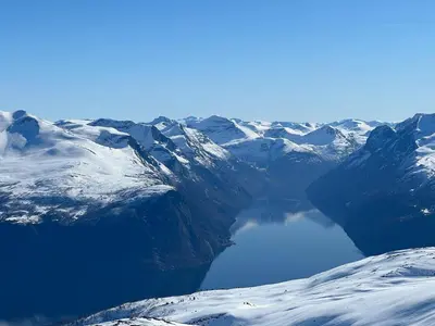 a view of a snow covered mountain with a lake at The View - Mountain cabin with stunning views in Stranda