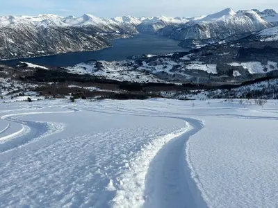 an aerial view of a snow covered lake and mountains at The View - Mountain cabin with stunning views in Stranda