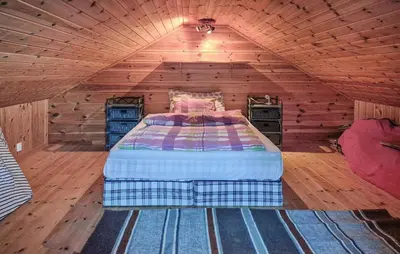 a bedroom with a bed in a wooden room at 3 Bedroom Stunning Home In Tansøy in Tansøy