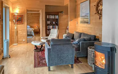 a living room with a couch and a fireplace at 3 Bedroom Stunning Home In Tansøy in Tansøy