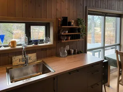 a kitchen with a sink and a wooden counter top at Cabin With Sauna At Norefjell in Noresund