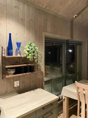 a dining room with a table and a blue vase at Cabin With Sauna At Norefjell in Noresund