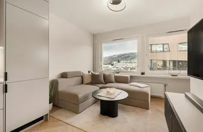 a living room with a couch and a table at Modern and cozy apartment ONLY 5 minutes from City Center in Bergen