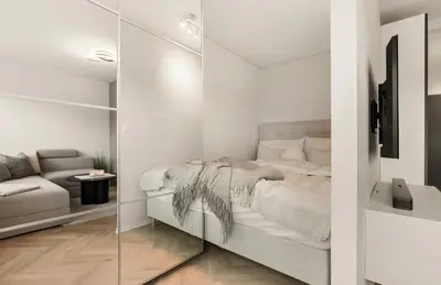 a white bedroom with a bed and a glass wall at Modern and cozy apartment ONLY 5 minutes from City Center in Bergen