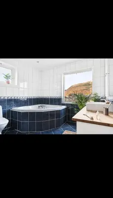a bathroom with a tub and a sink at Great apartment overlooking Bergen in Bergen