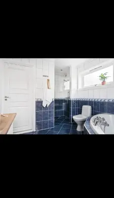 a bathroom with a tub and a toilet and a sink at Great apartment overlooking Bergen in Bergen