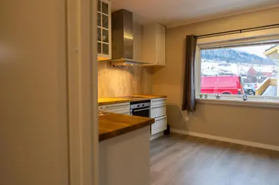 a kitchen with a counter top and a window at Spacious Apartment - City Center in Stryn