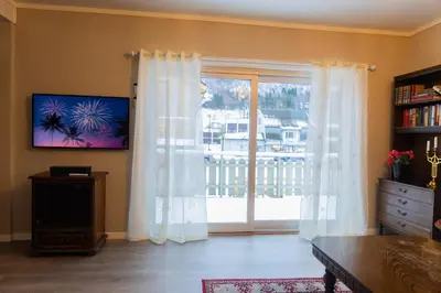 a living room with a large window with curtains at Spacious Apartment - City Center in Stryn