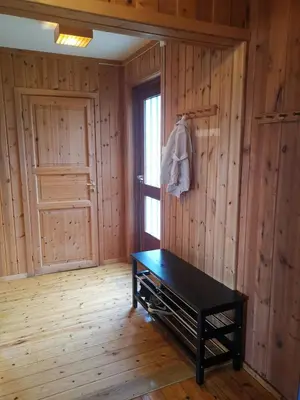 a room with a black table and a door at Åsrud seter i Jotunheimen in Vaga