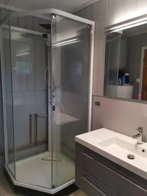 a bathroom with a glass shower and a sink at Åsrud seter i Jotunheimen in Vaga
