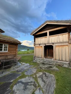 a log cabin with a picnic table in front of it at Gunhild-stugu i Jotunheimen
