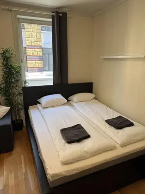 a bedroom with a bed with two towels on it at Cozy Studio in Lademoen, Trondheim in Trondheim