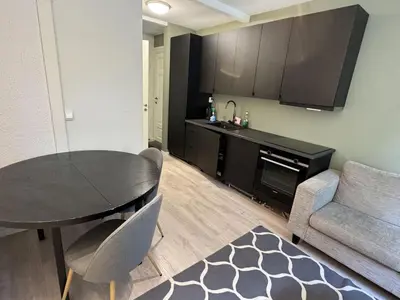 a living room with a table and a couch at Perfect central apartment Trondheim in Trondheim
