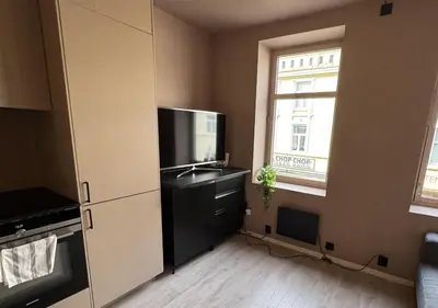 a kitchen with a television and a dresser with a sink at Modern and central apartment in Trondheim in Trondheim