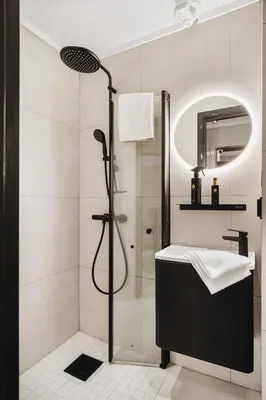 a bathroom with a shower and a sink at Central apartment building in Bergen