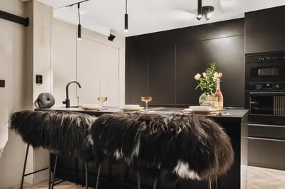 a kitchen with a black island with feathers on it at Central apartment building in Bergen