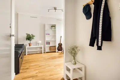 a room with a hallway with a door open and a room with a guitar at Appartment Bergen, Skansen in Bergen