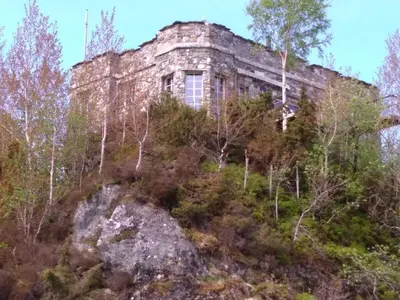 an old building on top of a hill with trees at Haven Fortress in Lii
